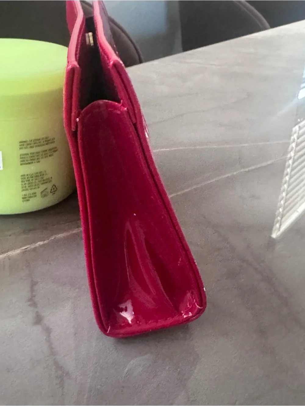 This is a bright red patent PVC Yves Saint Laurent Beauté cosmetic bag featuring